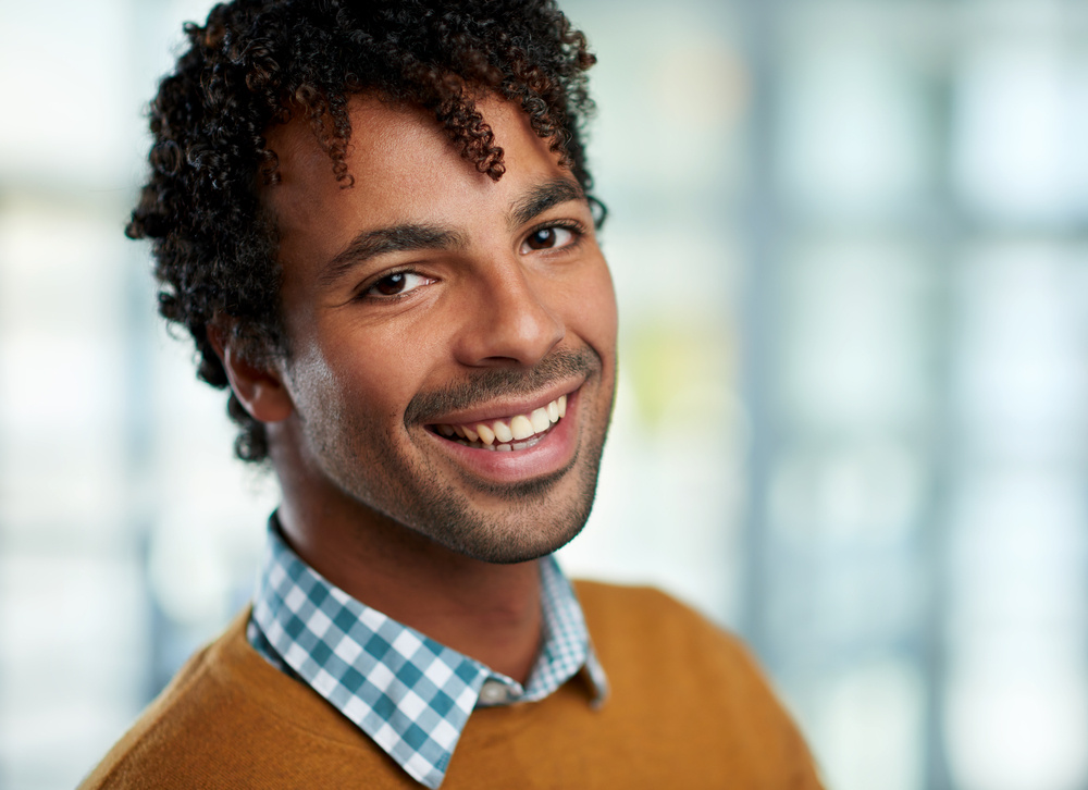 Horizontal headshot of an attractive african american businessman shot with shallow depth field.