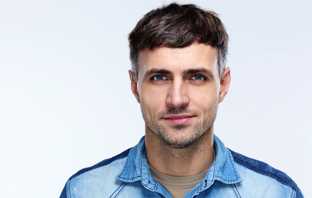 Portrait of a happy man over gray background